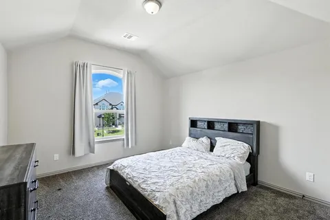 a bedroom with a bed and window