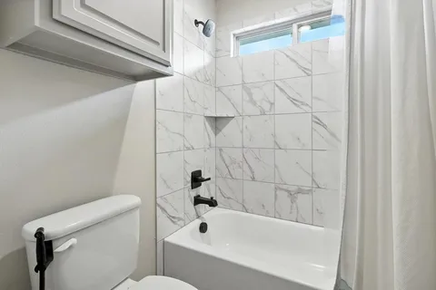 a bathroom with a bathtub and a toilet