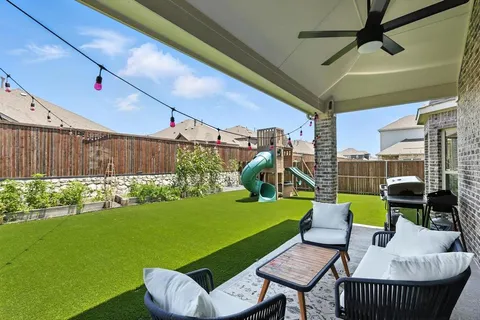 a view of a patio with couches chairs and a yard