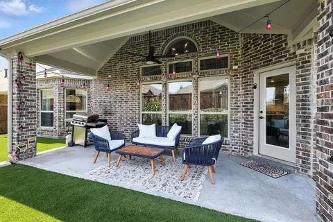 a view of a house with a porch and a bench