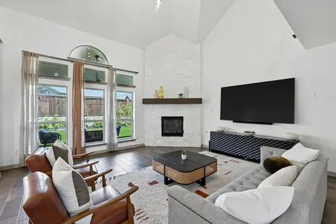 a living room with furniture fireplace and a flat screen tv