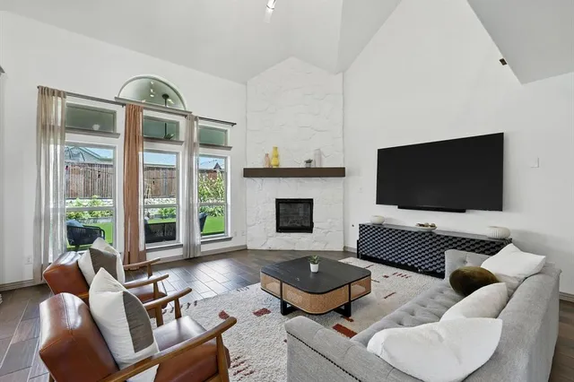 a living room with furniture fireplace and a flat screen tv