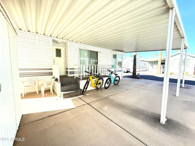 a view of a patio with table and chairs under an umbrella