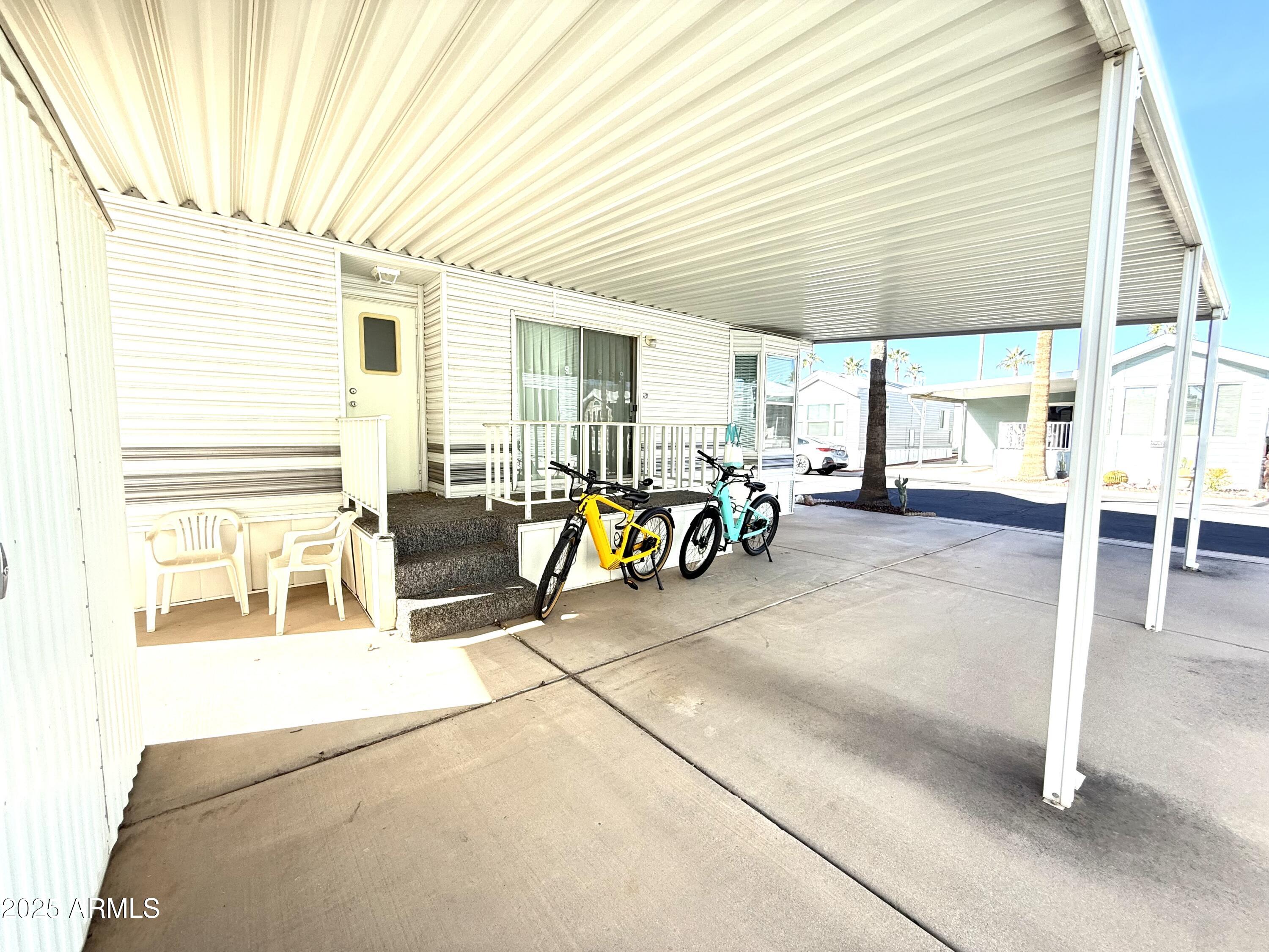 646 Hawks Eye Drive Apache Junction, AZ 85119 - Photo 4 of 17 a view of a patio with table and chairs under an umbrella