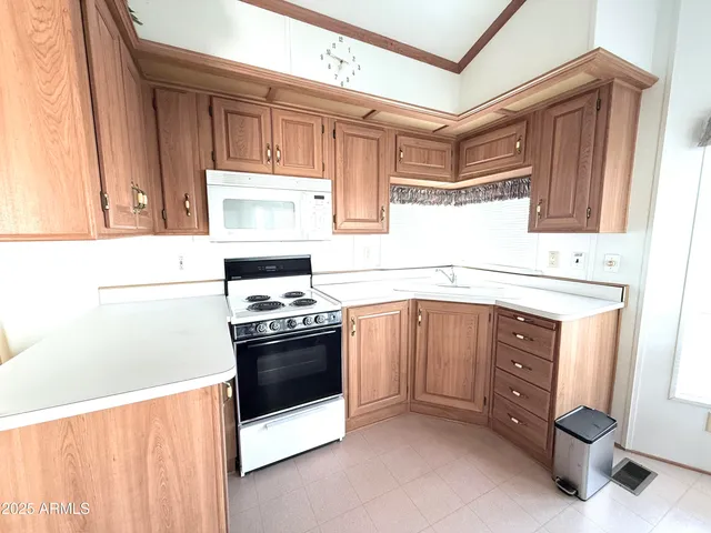 a kitchen with stainless steel appliances granite countertop a stove and a microwave