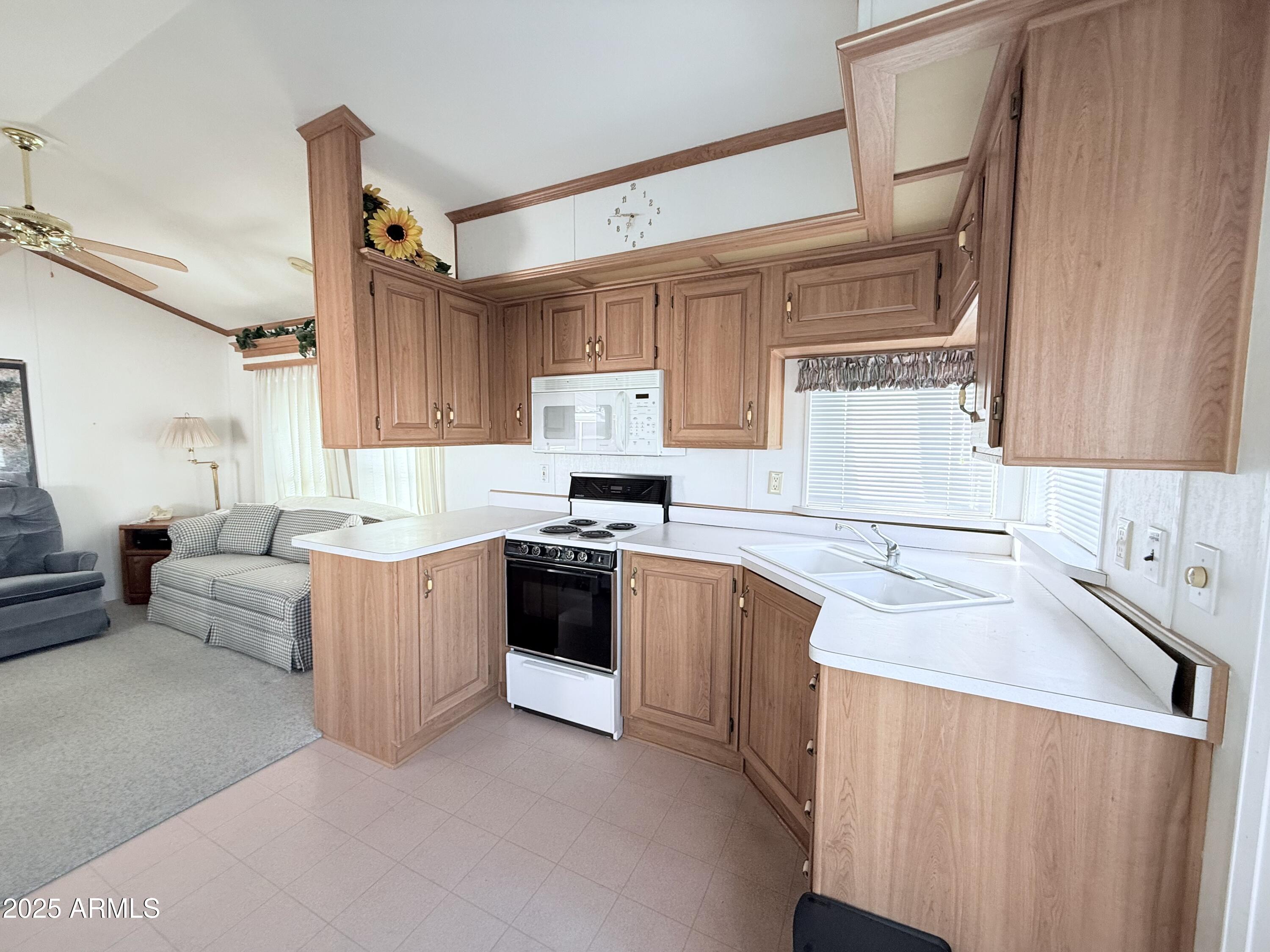 646 Hawks Eye Drive Apache Junction, AZ 85119 - Photo 10 of 17 a kitchen with granite countertop a sink stove and cabinets
