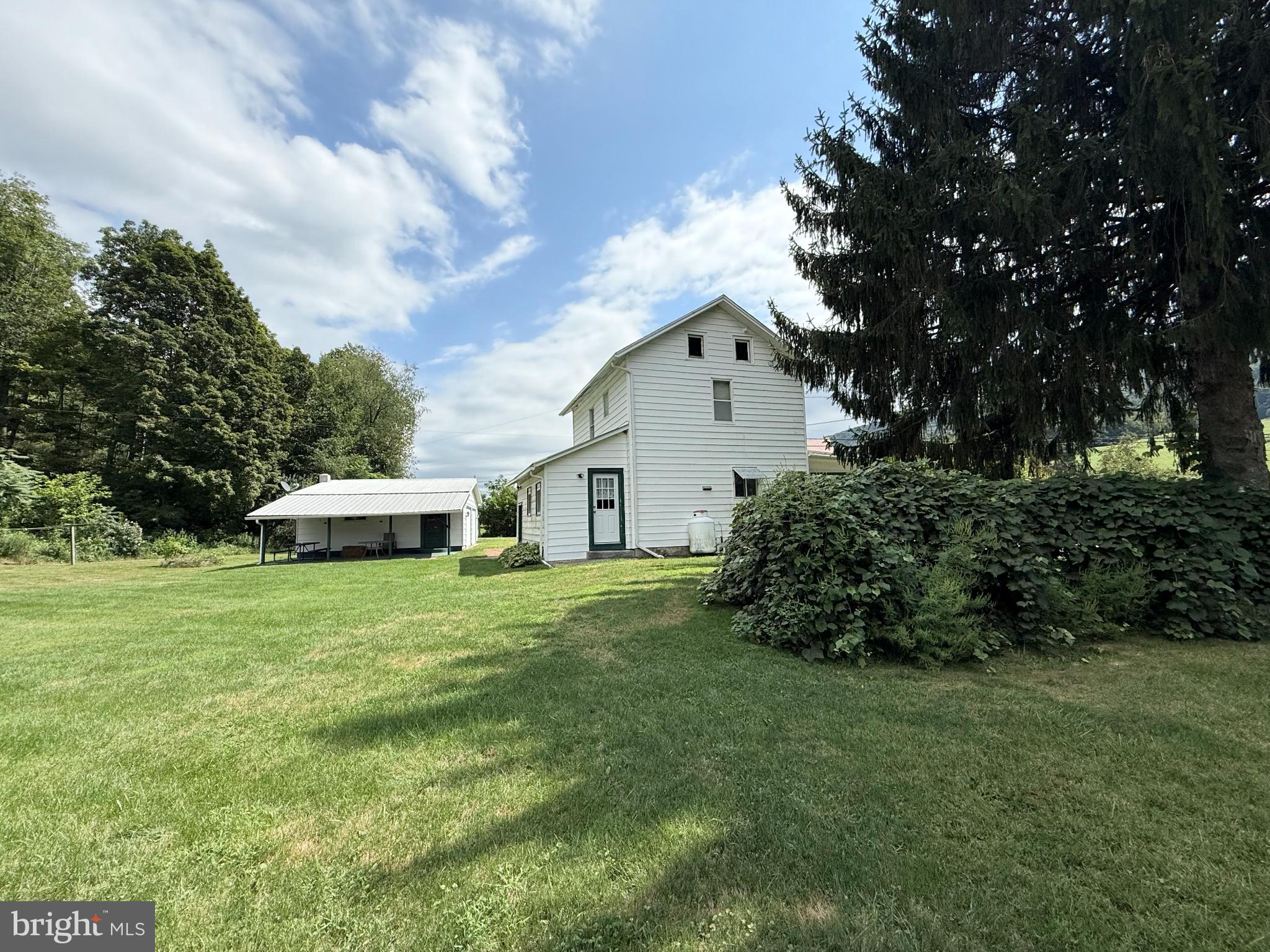 1329 Summer Mountain Road Loganton, PA 17747 - Photo 7 of 56 a front view of a house with a garden
