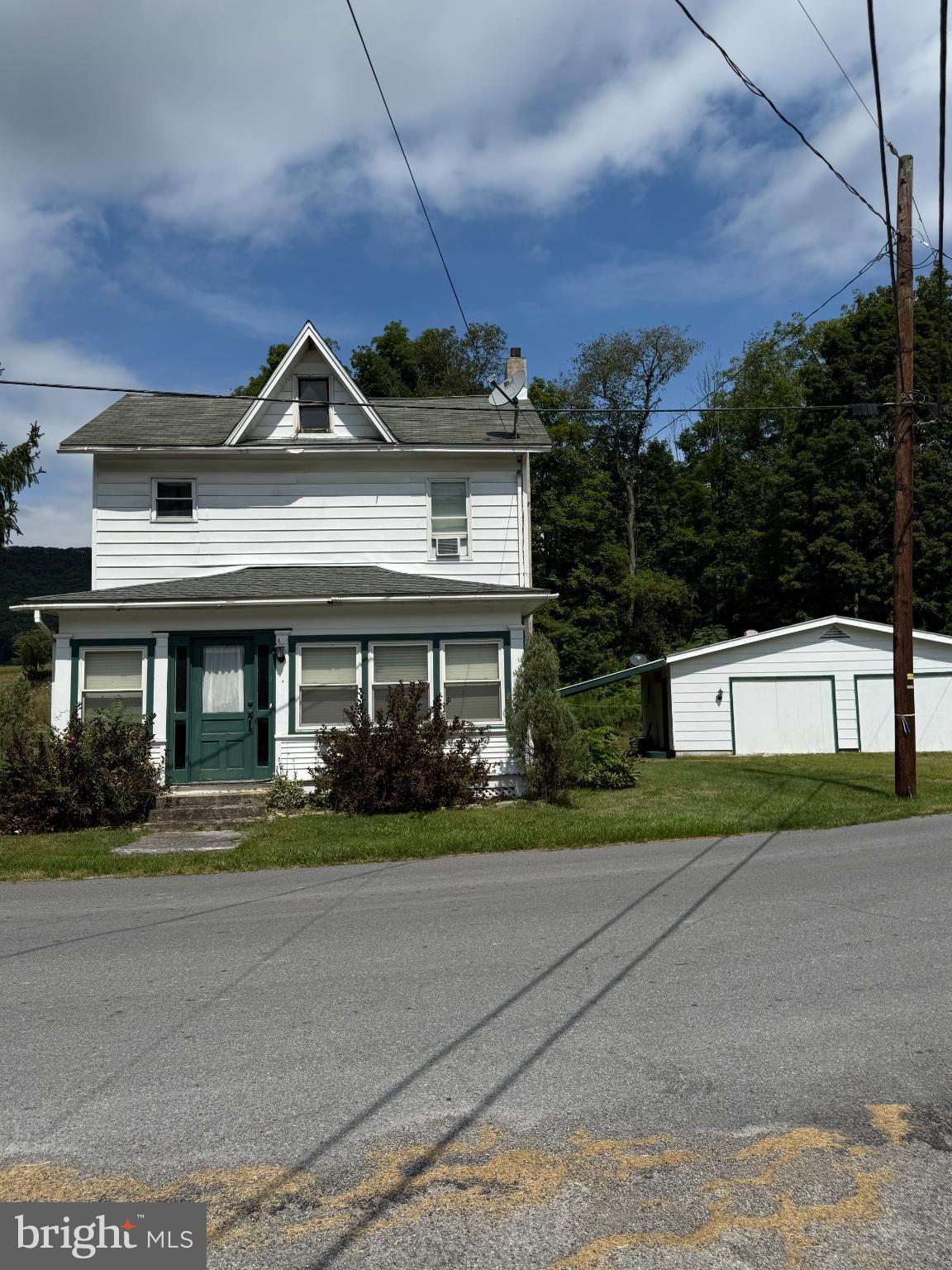 1329 Summer Mountain Road Loganton, PA 17747 - Photo 8 of 56 a front view of a house with a yard and garage