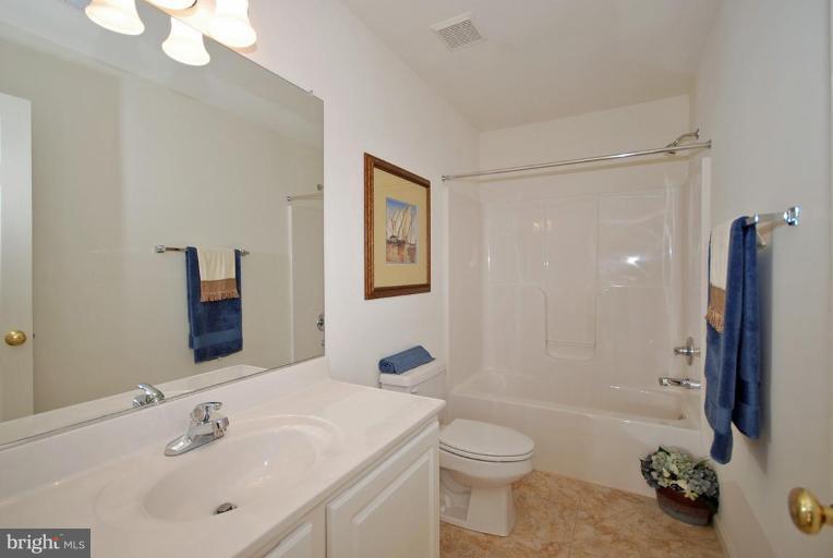 5970 Florey Road Hanover, MD 21076 - Photo 21 of 30 a bathroom with a sink toilet and shower