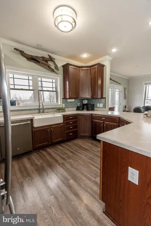 a large kitchen with stainless steel appliances a stove a sink a refrigerator and a island