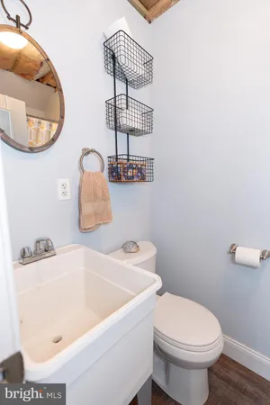 a bathroom with a sink a toilet and a mirror