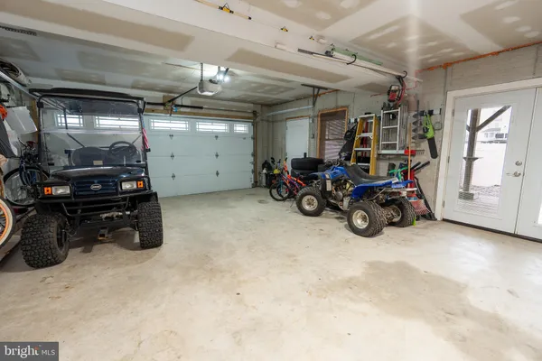 a view of a garage with a bike and car