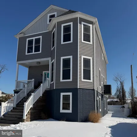 a front view of a house with many windows