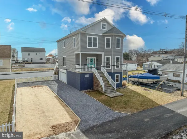 a view of a kitchen with kitchen island and a sink
