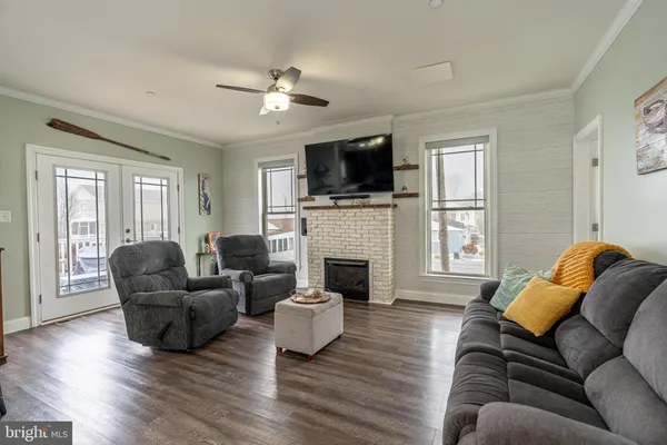 a living room with furniture a flat screen tv and a fireplace