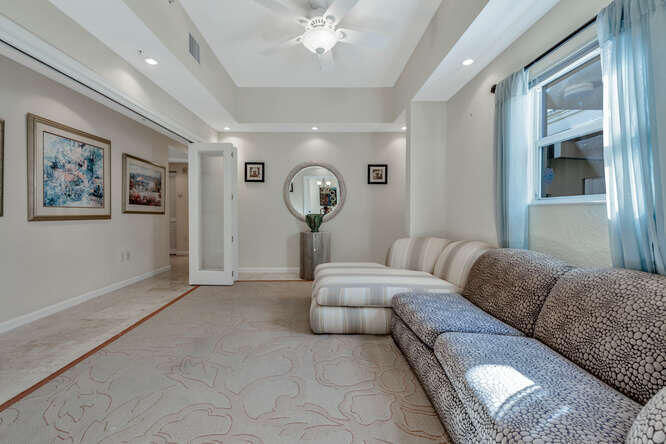1640 Presidential Way, Unit 501 West Palm Beach, FL 33401 - Photo 14 of 36 a living room with furniture and a large window