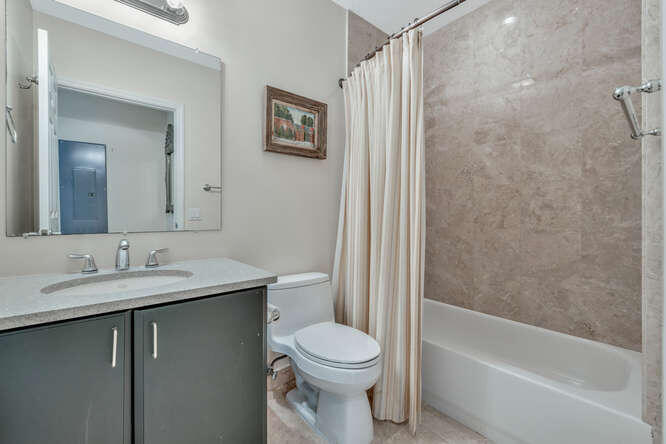 1640 Presidential Way, Unit 501 West Palm Beach, FL 33401 - Photo 15 of 36 a bathroom with a granite countertop sink toilet and shower