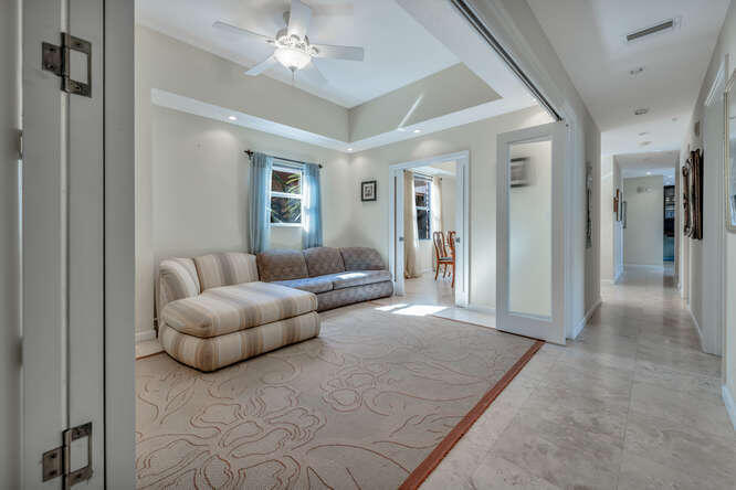 1640 Presidential Way, Unit 501 West Palm Beach, FL 33401 - Photo 23 of 36 a living room with furniture and a chandelier