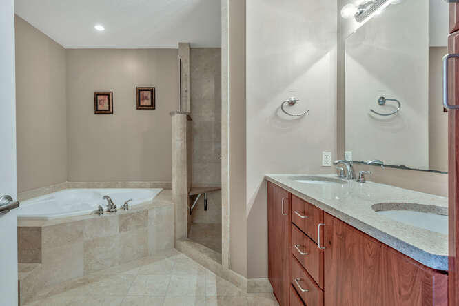 1640 Presidential Way, Unit 501 West Palm Beach, FL 33401 - Photo 25 of 36 a bathroom with a tub sink and mirror