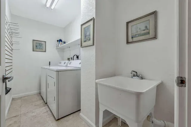 a kitchen with stainless steel appliances granite countertop a sink and a refrigerator