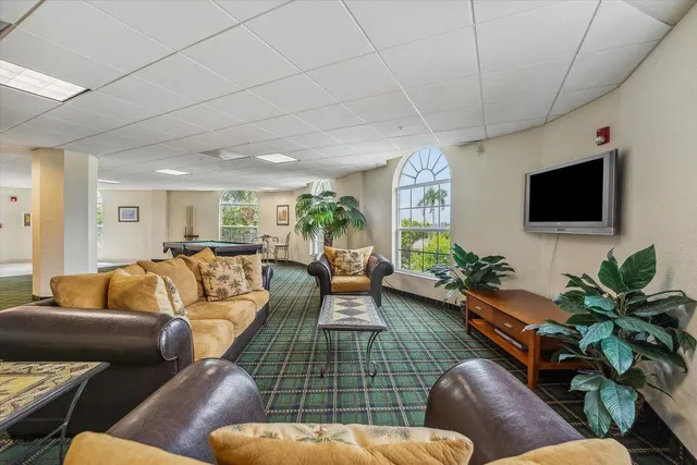 a room with pool table and windows