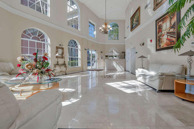 1640 Presidential Way, Unit 501 West Palm Beach, FL 33401 - Photo 34 of 36 a view of a living room and chandelier