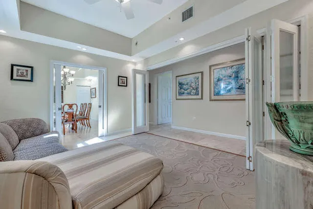 a living room with furniture a fireplace and a large window