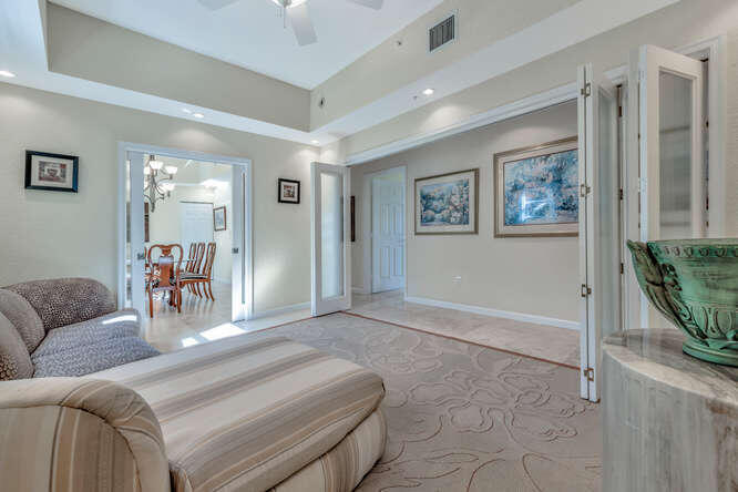 1640 Presidential Way, Unit 501 West Palm Beach, FL 33401 - Photo 5 of 36 a living room with furniture and a dining table