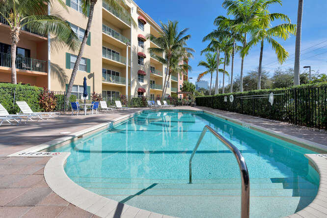 1640 Presidential Way, Unit 501 West Palm Beach, FL 33401 - Photo 10 of 36 a view of a swimming pool with a bench