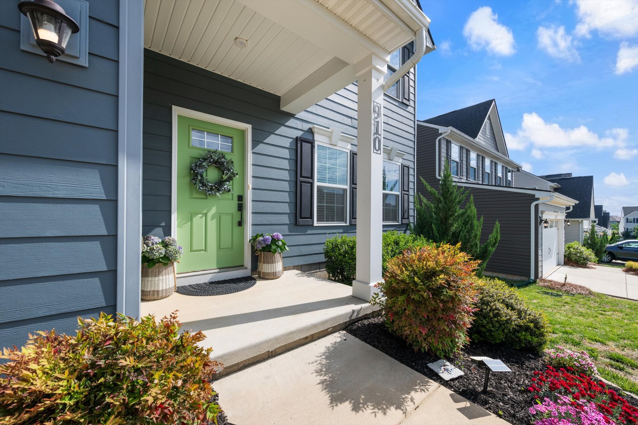 910 Caywood Road Smyrna, TN 37167 - Photo 32 of 49 a view of a house with potted plants and a bench