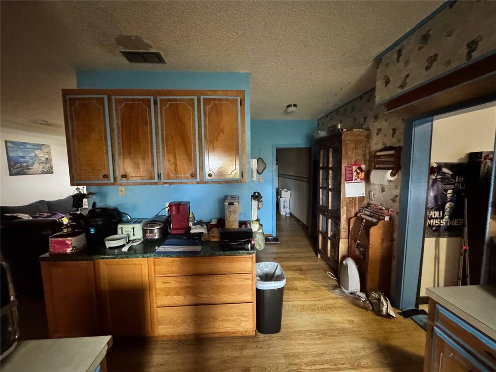 350 Quail Meadow Road Seadrift, TX 77983 - Photo 11 of 22 a kitchen with blue cabinets and black appliances