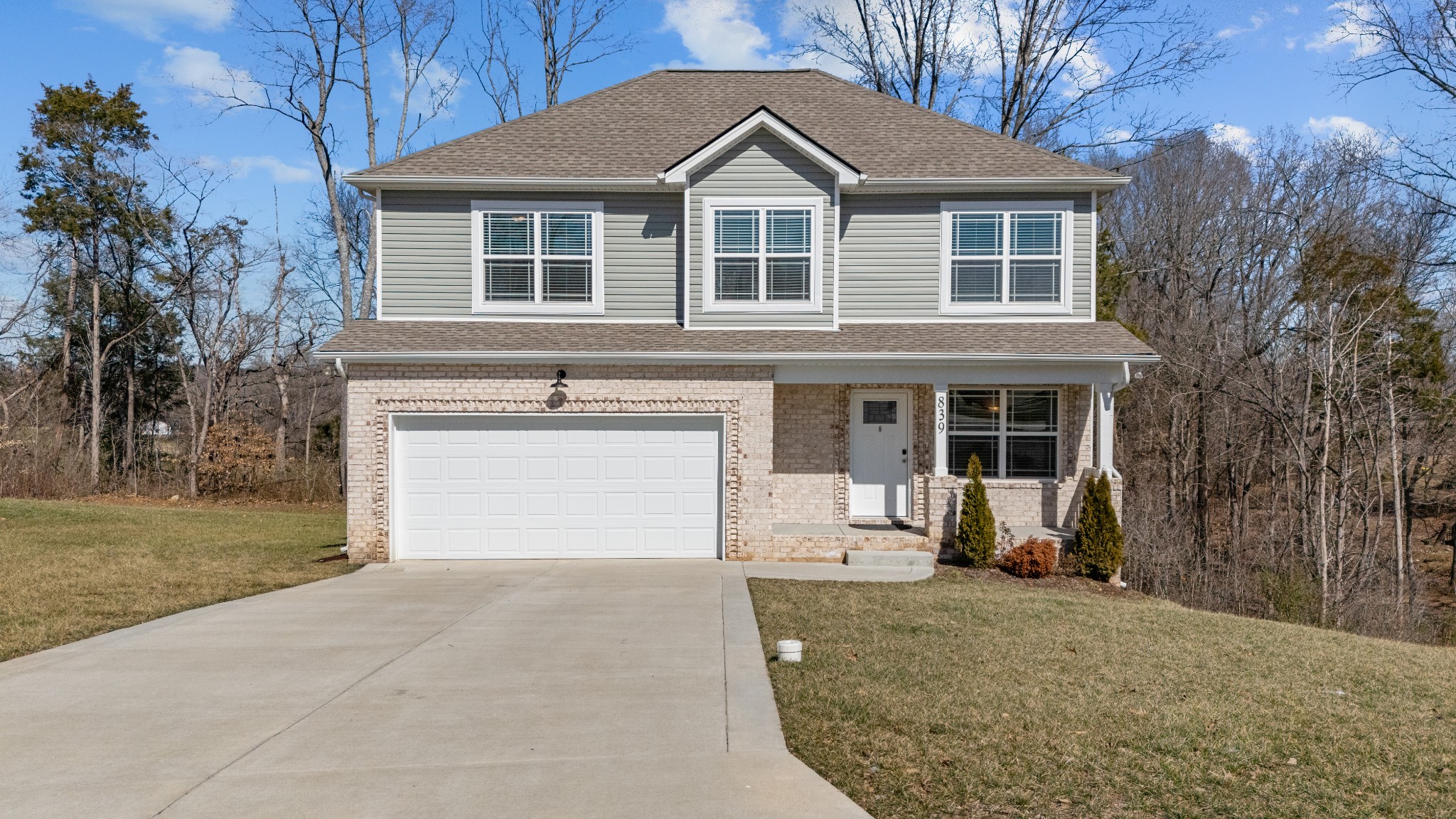 839 Cedar Lane Springfield, TN 37172 - Photo 2 of 34 a front view of a house with a yard and garage