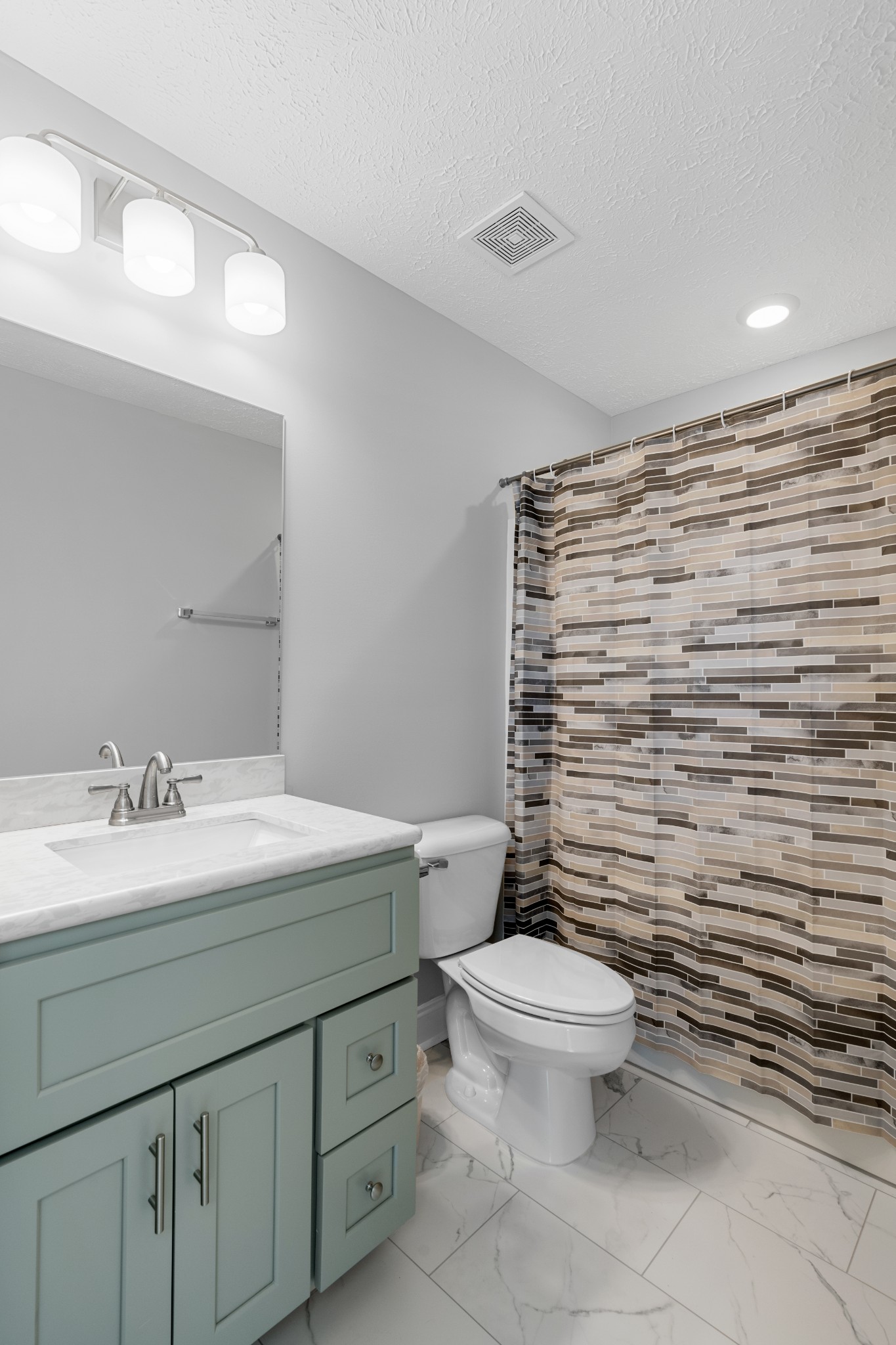 839 Cedar Lane Springfield, TN 37172 - Photo 23 of 34 a bathroom with a granite countertop toilet a sink a mirror and a shower