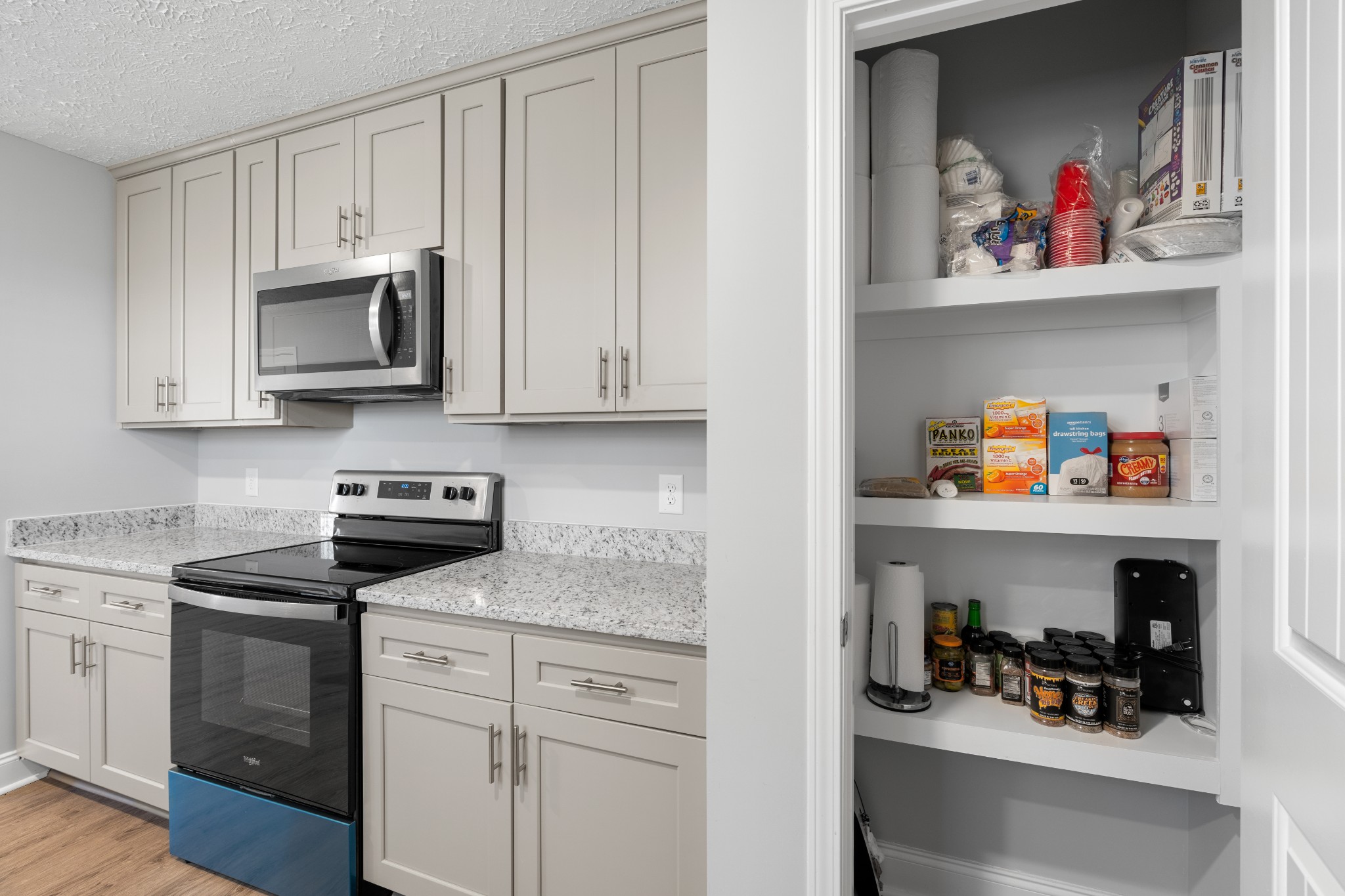 839 Cedar Lane Springfield, TN 37172 - Photo 10 of 34 a kitchen with white cabinets and black appliances