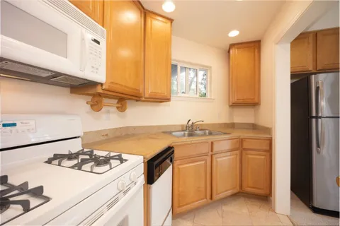 a kitchen with a sink stove and refrigerator