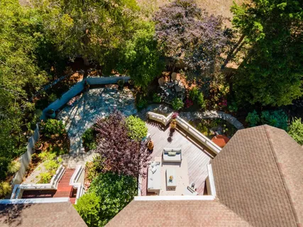 an aerial view of a house with a yard