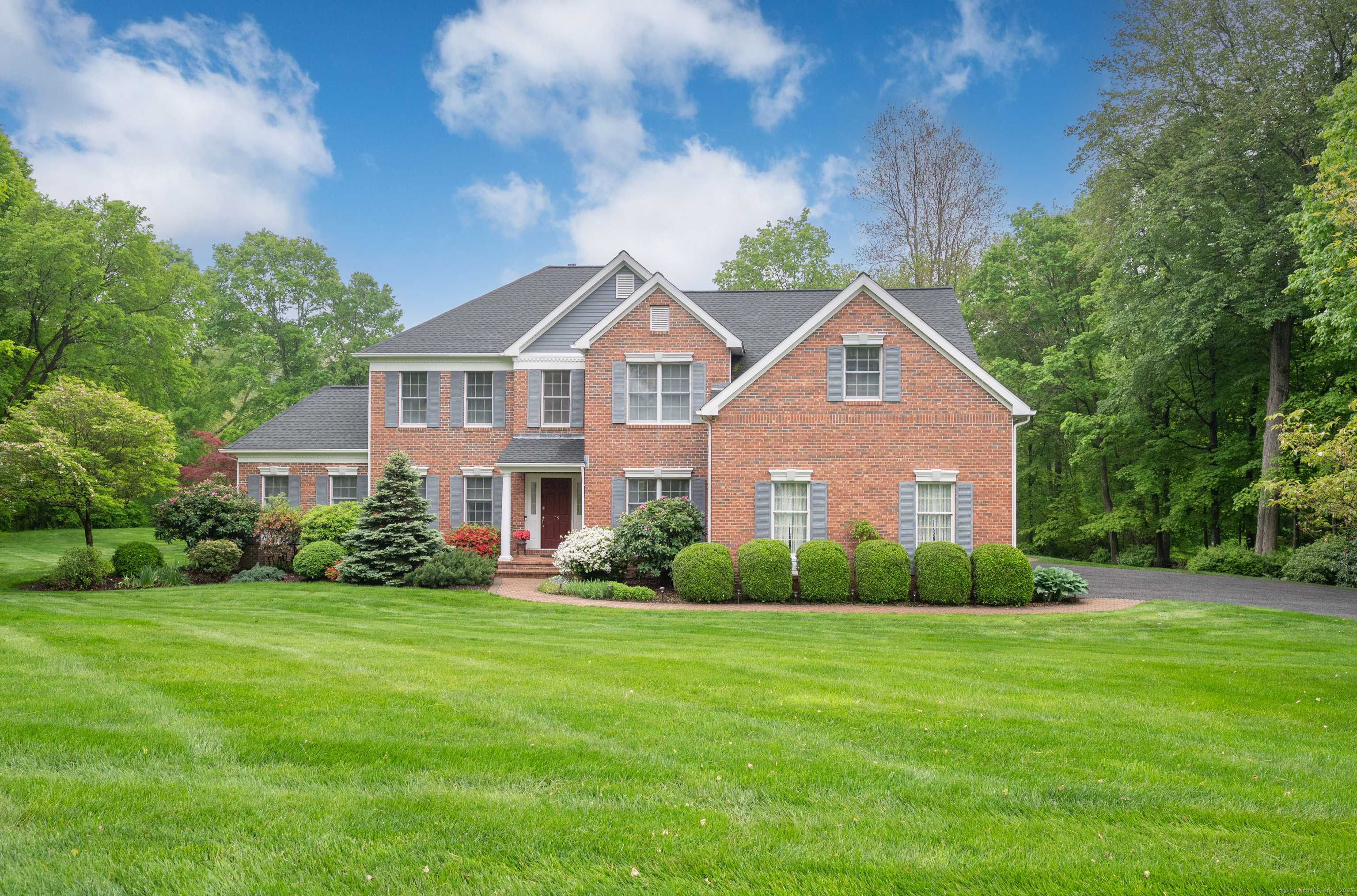 28 Whitewood Road Newtown, CT 06470 - Photo 1 of 1 a front view of house with yard and green space