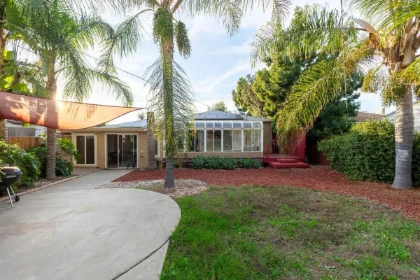 a front view of a house with a garden and patio