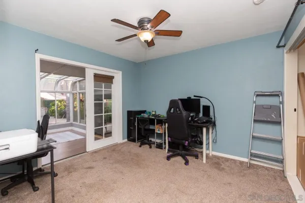 a view of a workspace with furniture and a window