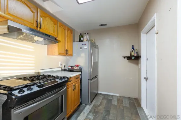 a kitchen with a stove and a refrigerator