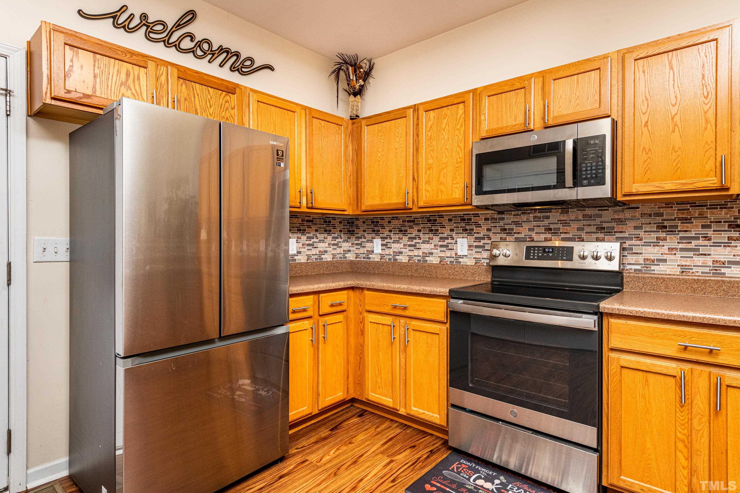 1208 Wall Street Durham, NC 27701 - Photo 12 of 27 a kitchen with stainless steel appliances a refrigerator stove and microwave