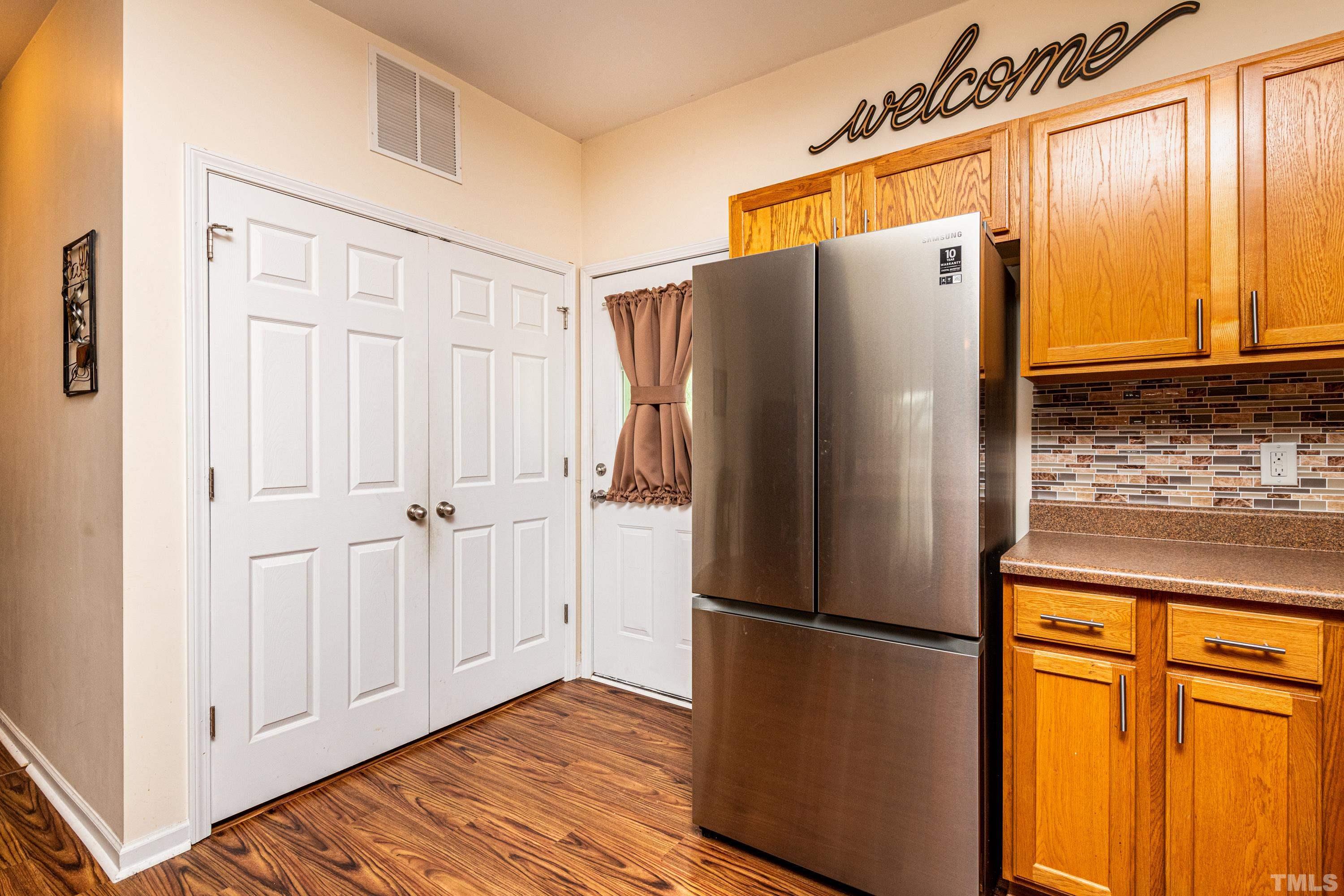 1208 Wall Street Durham, NC 27701 - Photo 14 of 27 a metallic refrigerator freezer sitting in a kitchen