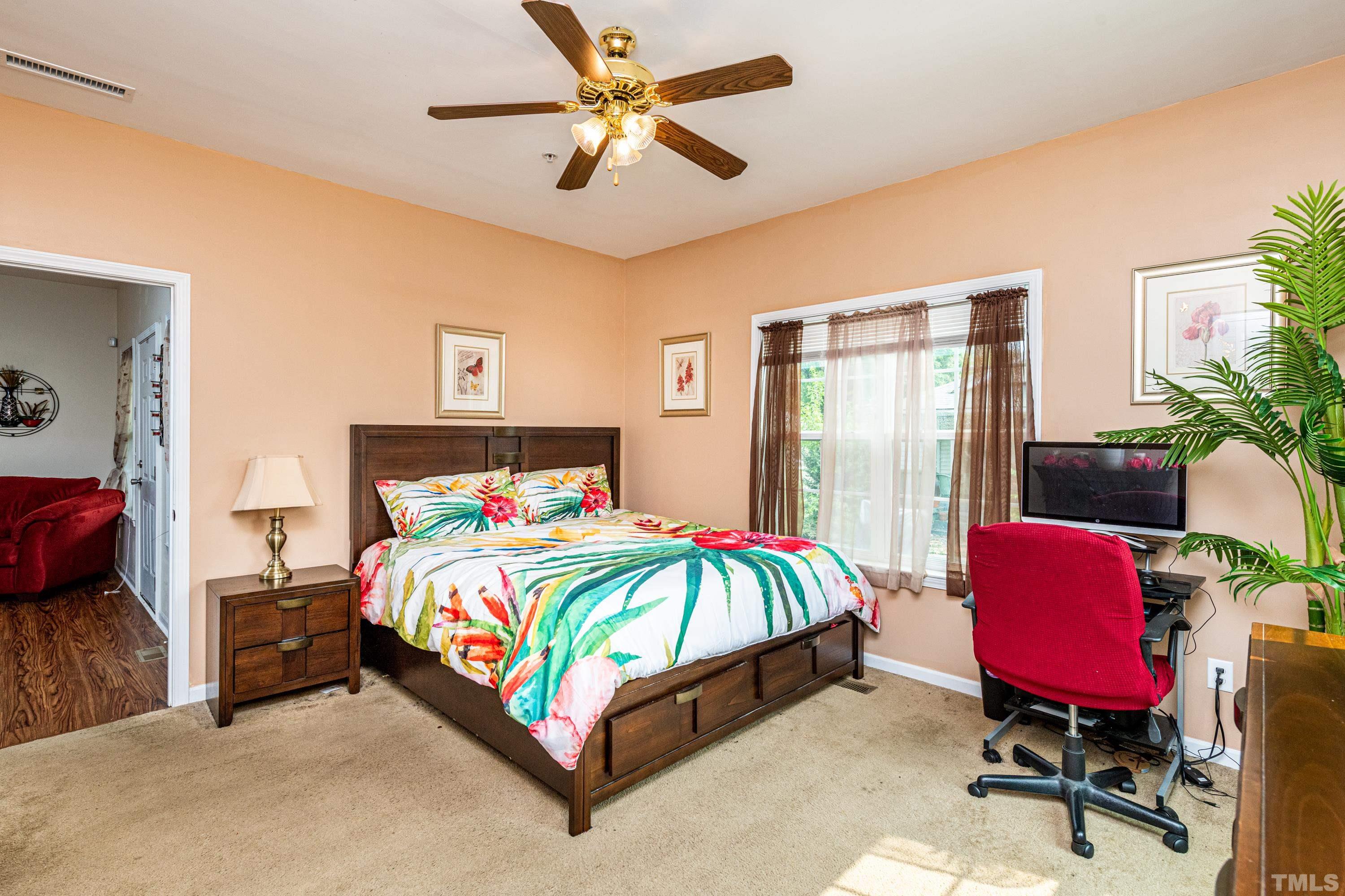 1208 Wall Street Durham, NC 27701 - Photo 16 of 27 a bedroom with a bed a desk and chair with a potted plant on a dresser