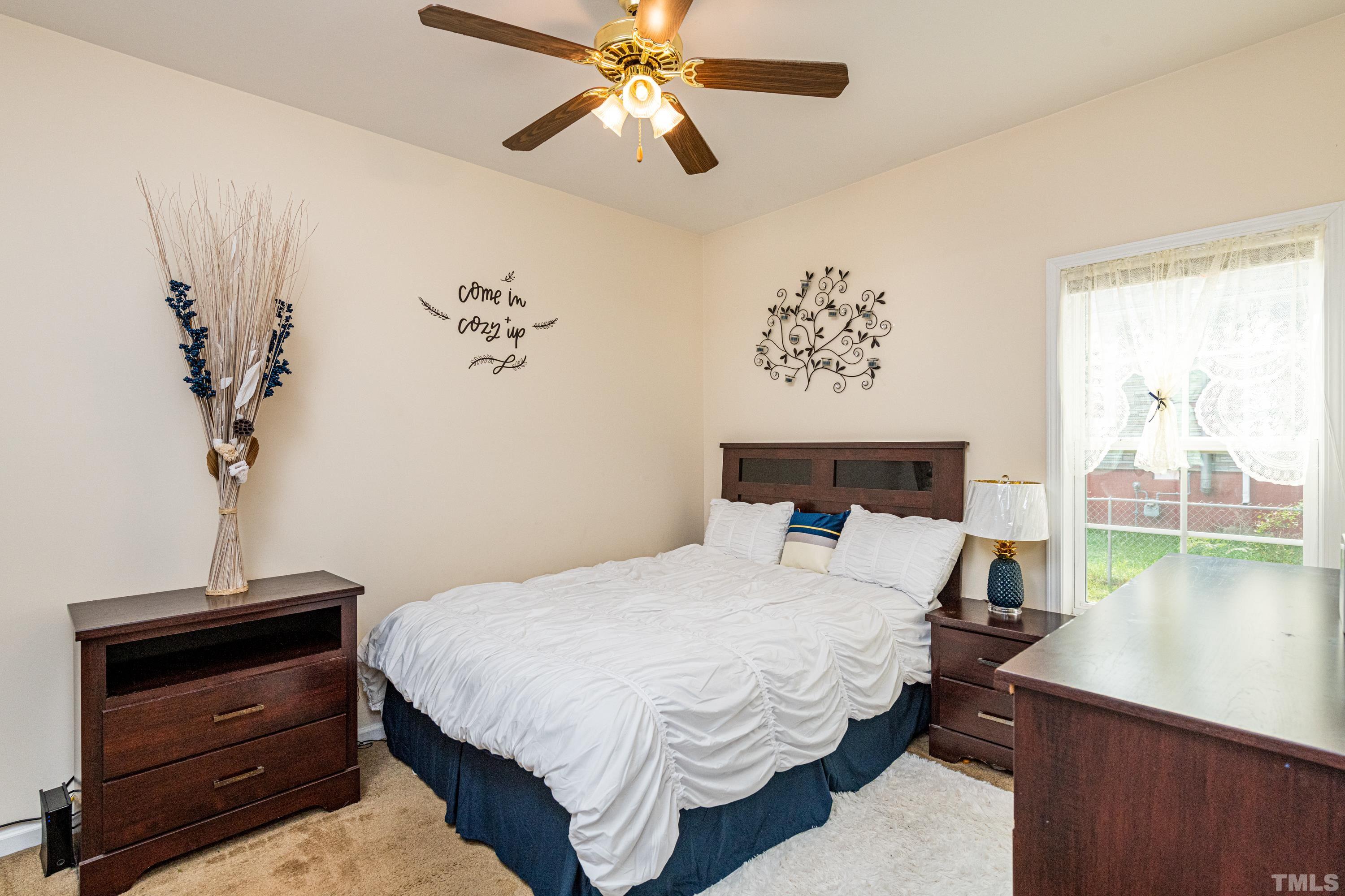 1208 Wall Street Durham, NC 27701 - Photo 19 of 27 a bedroom with a bed and a chandelier
