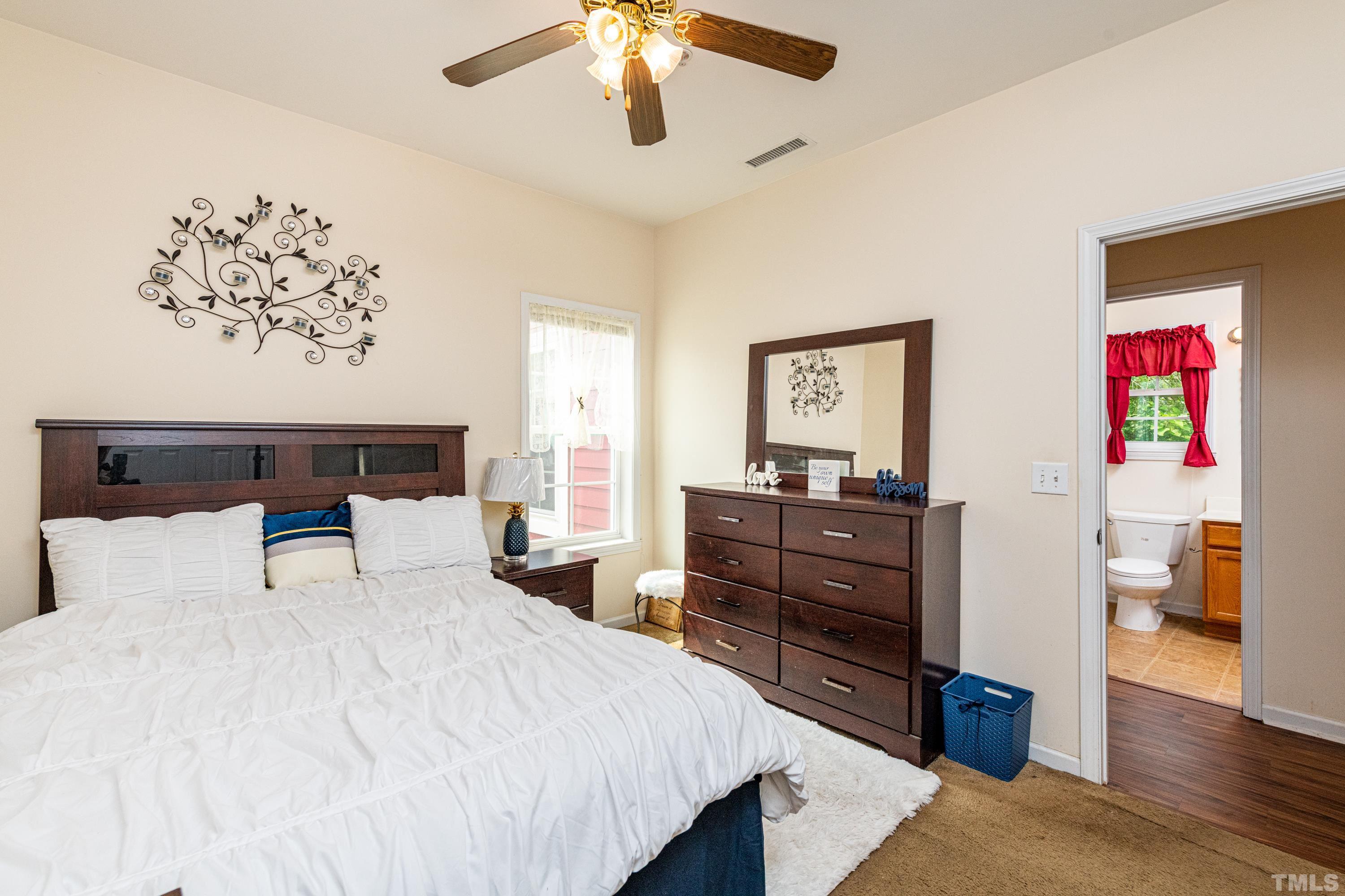 1208 Wall Street Durham, NC 27701 - Photo 20 of 27 a bedroom with a bed and a chandelier