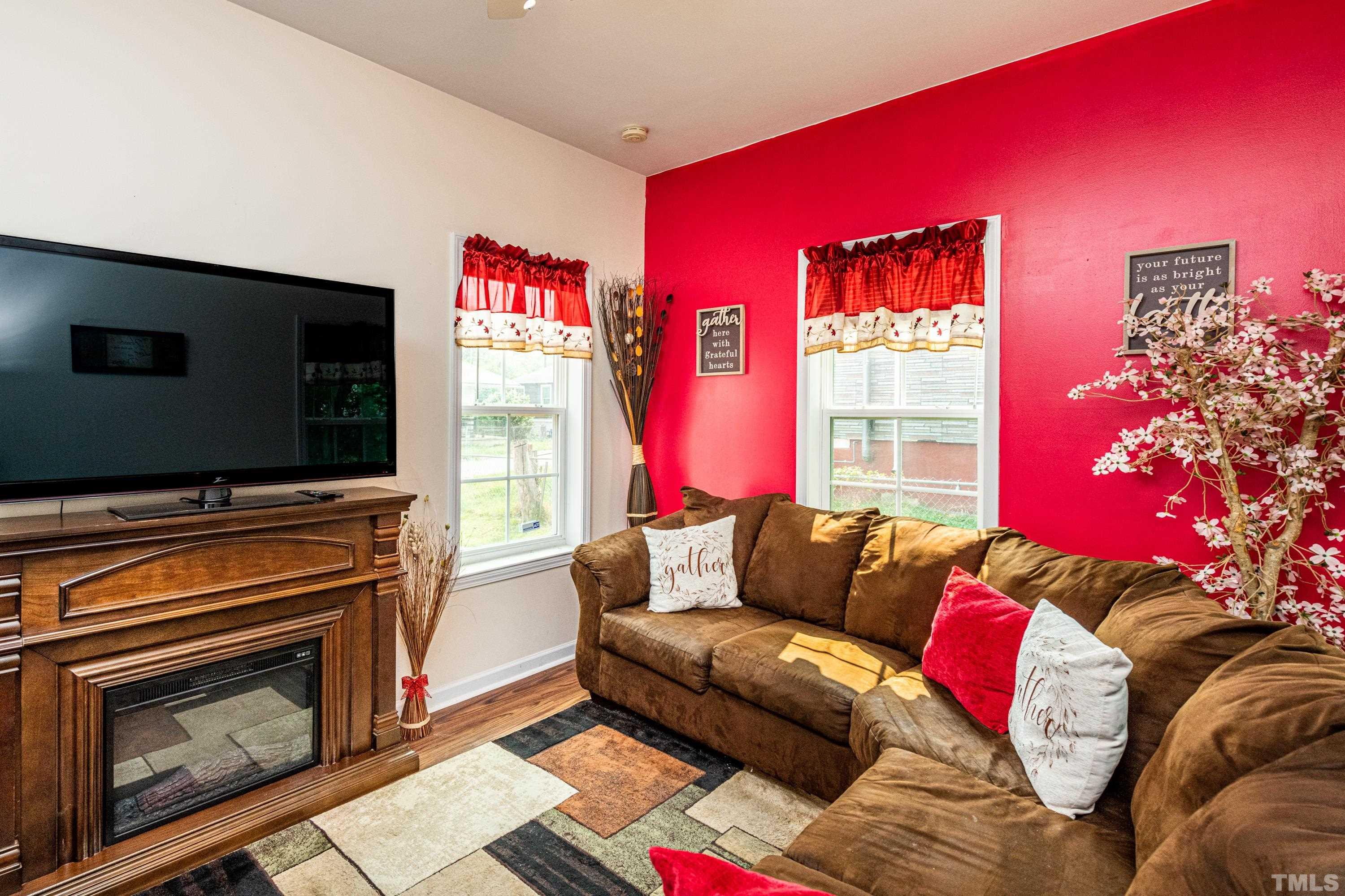 1208 Wall Street Durham, NC 27701 - Photo 23 of 27 a living room with furniture a flat screen tv and a fireplace