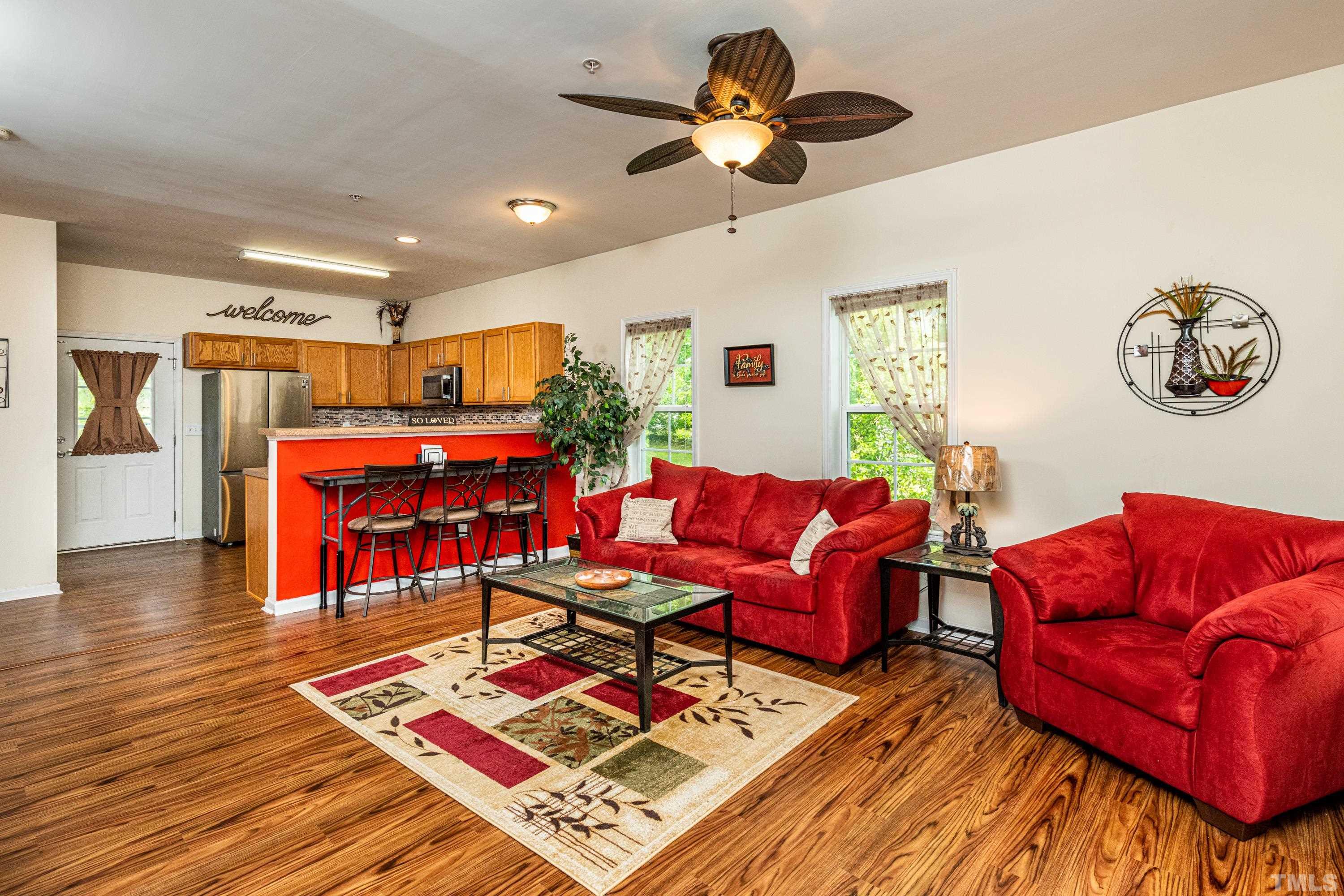 1208 Wall Street Durham, NC 27701 - Photo 9 of 27 a living room with furniture a rug and a chandelier