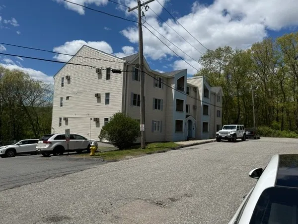 a view of a cars park in front of a building