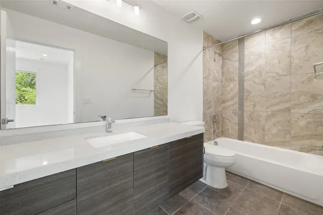 an empty room with a window and a ceiling fan