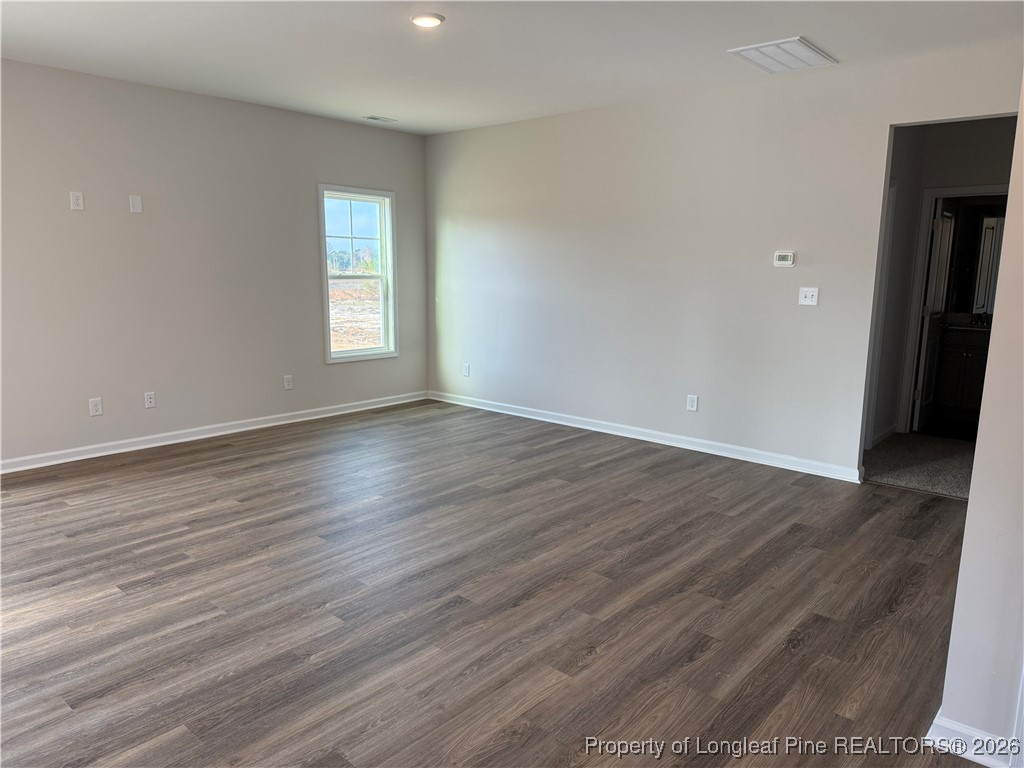 471 Ashley Hts Drive Aberdeen, NC 28315 - Photo 13 of 38 a view of an empty room with wooden floor and a window
